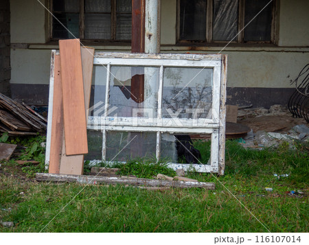 An old broken window among the debris. Construction rubbish. Dump. Place of repair 116107014