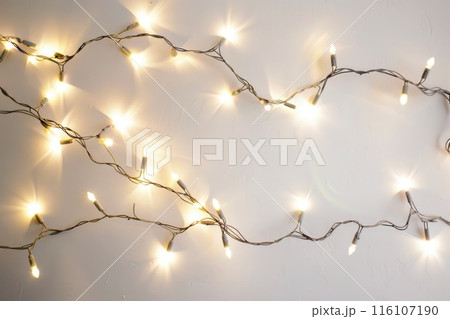 Illuminated String Lights on a Plain Background for Festive Decor Illuminated String Lights on a Plain Background for Festive Decor 116107190