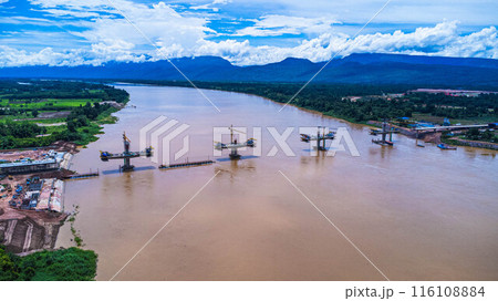 Aerial view of the construction site of the bridge over the Mekong River. Construction of a new Thai-Lao Friendship Bridge in Bueng Kan Province, Thailand. 116108884