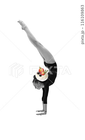 Black and white image of female gymnast performing handstand, with a plate of colorful dessert topped with fruit and whipped cream. Contemporary art collage. 116109863