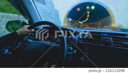 People driving car in tunnel 116112096