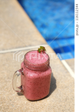Refreshing Berry Smoothie Poolside on Sunny Day Refreshing Berry Smoothie Poolside on Sunny Day 116112344