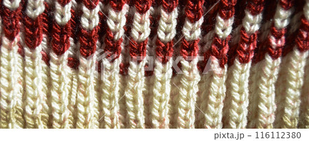 Handmade knitted fabric red and white wool background texture 116112380