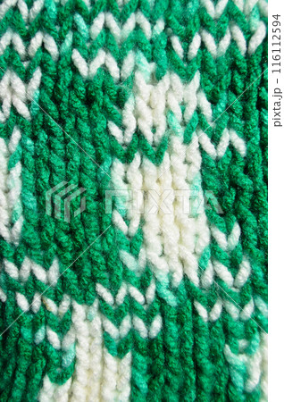 Handmade knitted fabric green and white wool background texture 116112594