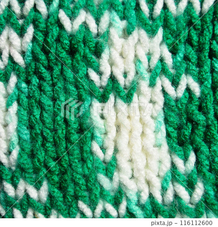 Handmade knitted fabric green and white wool background texture Handmade knitted fabric green and white wool background texture 116112600