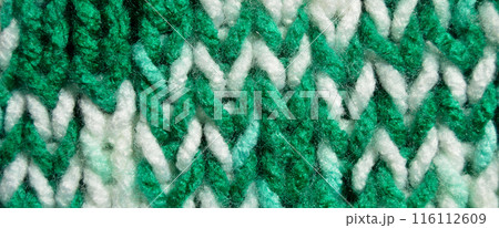 Handmade knitted fabric green and white wool background texture Handmade knitted fabric green and white wool background texture 116112609