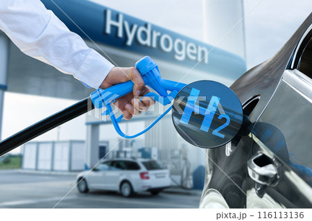 Man holds a hydrogen fueling nozzle. Refueling car with hydrogen fuel. Concept Man holds a hydrogen fueling nozzle. Refueling car with hydrogen fuel. Concept 116113136