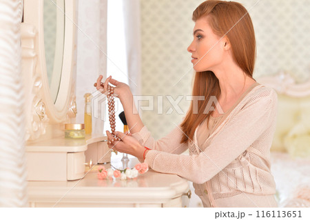 Portrait of beautiful girl doing makeup at home Portrait of beautiful girl doing makeup at home 116113651