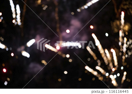 Gold rays of fireworks in smoke on a black background. Festive background. Gold rays of fireworks in smoke on a black background. Festive background. 116116445