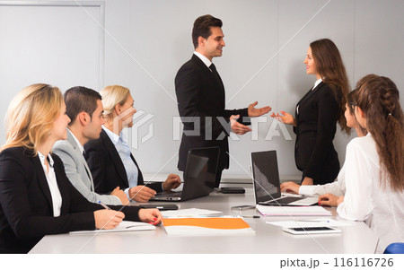 Meeting of clerks at large table 116116726