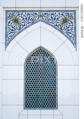 ceramic tile with a traditional Uzbek ornament with a oriental pattern. Window of white mosque Minor in Uzbekistan ceramic tile with a traditional Uzbek ornament with a oriental pattern. Window of white mosque Minor in Uzbekistan 116116993