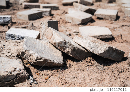 paving slabs on destroyed damaged pedestrian sidewalk close-up 116117011