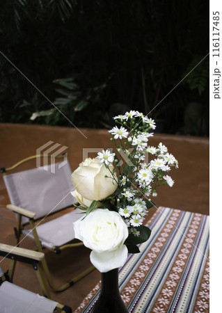 A coffee shop terrace with tables and chairs 116117485
