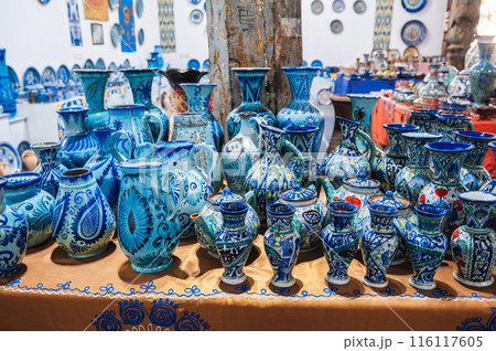 traditional Asian Uzbek ceramic vases, jugs and teapots hand-painted on oriental market in Uzbekistan 116117605