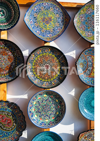 Uzbek ceramic plates hand-painted at oriental street bazaar in Uzbekistan in Tashkent 116117660