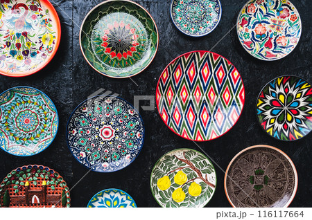 traditional oriental Uzbek ceramic plates hand painted on dark background traditional oriental Uzbek ceramic plates hand painted on dark background 116117664