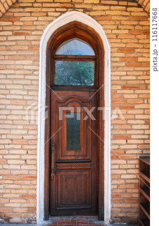 ancient carved wooden door to student room in Kukeldash madrasah with traditional pattern ornaments in Uzbekistan in Tashkent ancient carved wooden door to student room in Kukeldash madrasah with traditional pattern ornaments in Uzbekistan in Tashkent 116117668