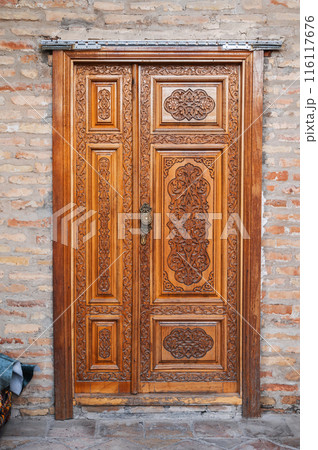carved wooden doors with tajik carved pattern with Islamic ornament in oriental kandakori style in Tadjikistan carved wooden doors with tajik carved pattern with Islamic ornament in oriental kandakori style in Tadjikistan 116117676
