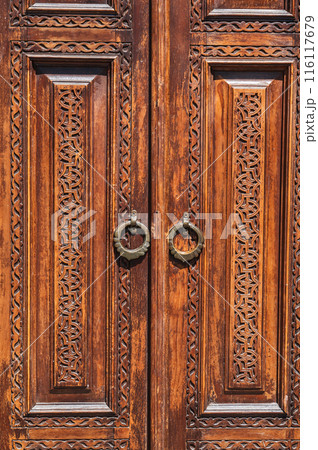 traditional Asian Uzbek patterns arabesque ornament on an ancient wooden carved door in Uzbekistan traditional Asian Uzbek patterns arabesque ornament on an ancient wooden carved door in Uzbekistan 116117679
