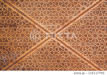 oriental Uzbek Islamic patterns ornament with stars on modern wooden carved door in Uzbekistan 116117760