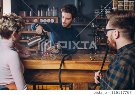 young attractive bearded guy serving a couple young attractive bearded guy serving a couple 116117767