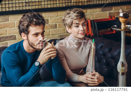 gorgeous young couple sitting at the cafe gorgeous young couple sitting at the cafe 116117791