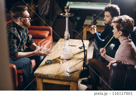 young ambitious business people are discussiong something at the restaurant 116117801