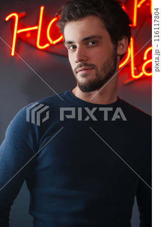 handsome cheerful man posing to the camera at night club 116117804