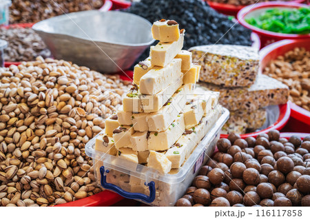 Uzbek halva, oriental sweets, dried fruits and various varieties of nuts at the Asian Uzbek bazaar on counter Uzbek halva, oriental sweets, dried fruits and various varieties of nuts at the Asian Uzbek bazaar on counter 116117858