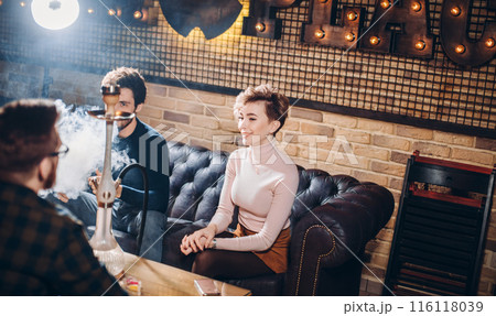 awesome young people having fun while smoking hookah 116118039