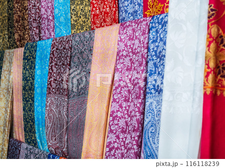 silk Turkish scarves with a bright colorful pattern at oriental bazaar in Turkey in Istanbul close-up 116118239