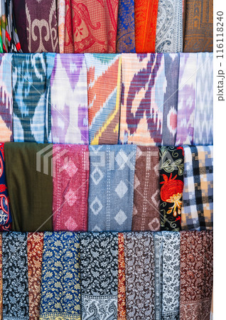 Asian scarves with bright colorful pattern at oriental bazaar in Uzbekistan close-up Asian scarves with bright colorful pattern at oriental bazaar in Uzbekistan close-up 116118240