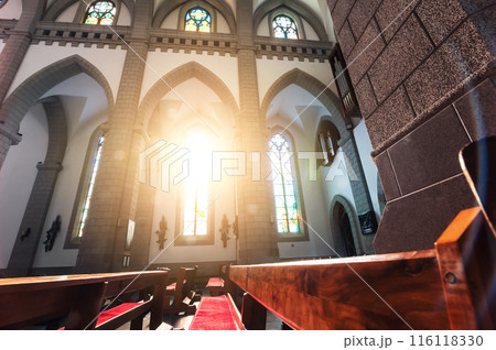 interior of Christian Catholic church with pews and sunlight. Cathedral of Sacred Heart of Jesus in Tashkent 116118330