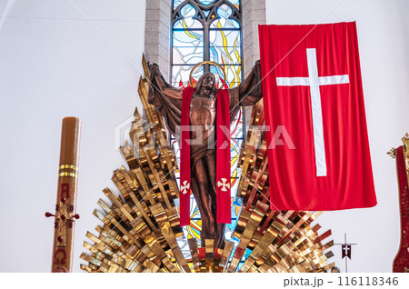altar with Jesus Christ and a cross inside of a white Christian Catholic church. Cathedral of the Sacred Heart of Jesus in Tashkent 116118346