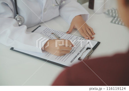Doctor prescribing medicine giving pills to senior grandmother patient at hospital. 116119124