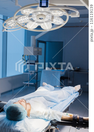 Male Patient prepared by a team of anesthetists for abdominal surgery, hospital Male Patient prepared by a team of anesthetists for abdominal surgery, hospital 116119139