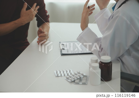 Doctor prescribing medicine giving pills to senior grandmother patient at hospital. 116119146
