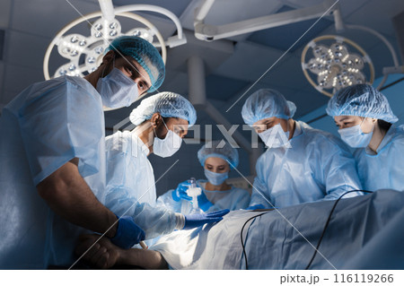 Surgeons perform a complex operation to save a human life at hospital 116119266