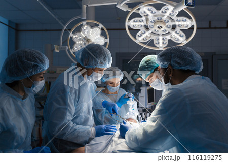 Surgeons perform a complex operation to save a human life at hospital 116119275