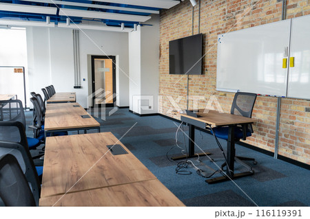 Empty room with tables and chairs for studying. University or school auditorium. Furniture in the interior. Modern style. Back to school. 116119391