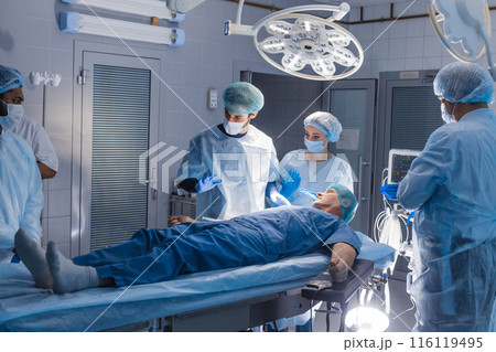 Surgery preparations. Surgical team preparing their patient for surgery 116119495