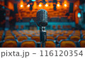 A Vintage Microphone Awaits On Stage In A Dark Auditorium 116120354