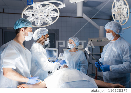 Surgeons perform a complex operation to save a human life at hospital Surgeons perform a complex operation to save a human life at hospital 116120375
