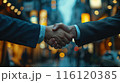 Business Professionals Shaking Hands In Urban Setting At Night 116120385