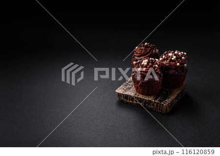 Delicious fresh muffins with filling and chocolate coating 116120859
