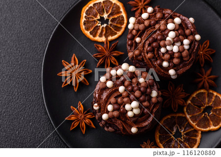 Delicious fresh muffins with filling and chocolate coating Delicious fresh muffins with filling and chocolate coating 116120880