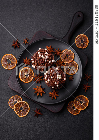 Delicious fresh muffins with filling and chocolate coating 116120889