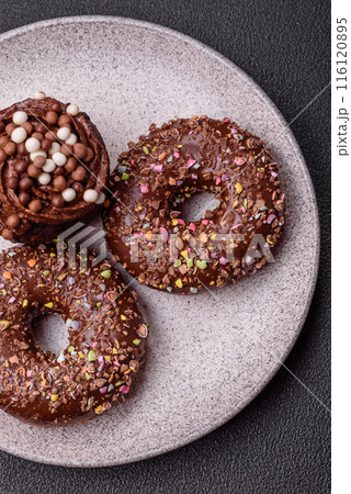 Delicious fresh donuts with filling and chocolate coating 116120895