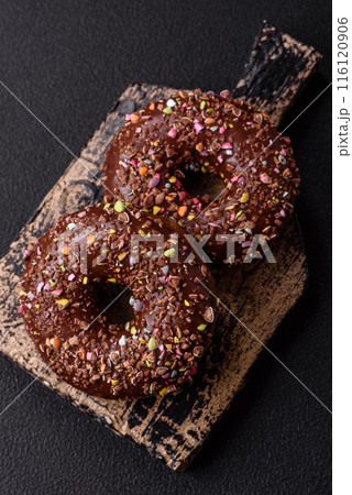 Delicious fresh donuts with filling and chocolate coating Delicious fresh donuts with filling and chocolate coating 116120906