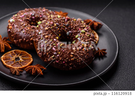 Delicious fresh donuts with filling and chocolate coating Delicious fresh donuts with filling and chocolate coating 116120918